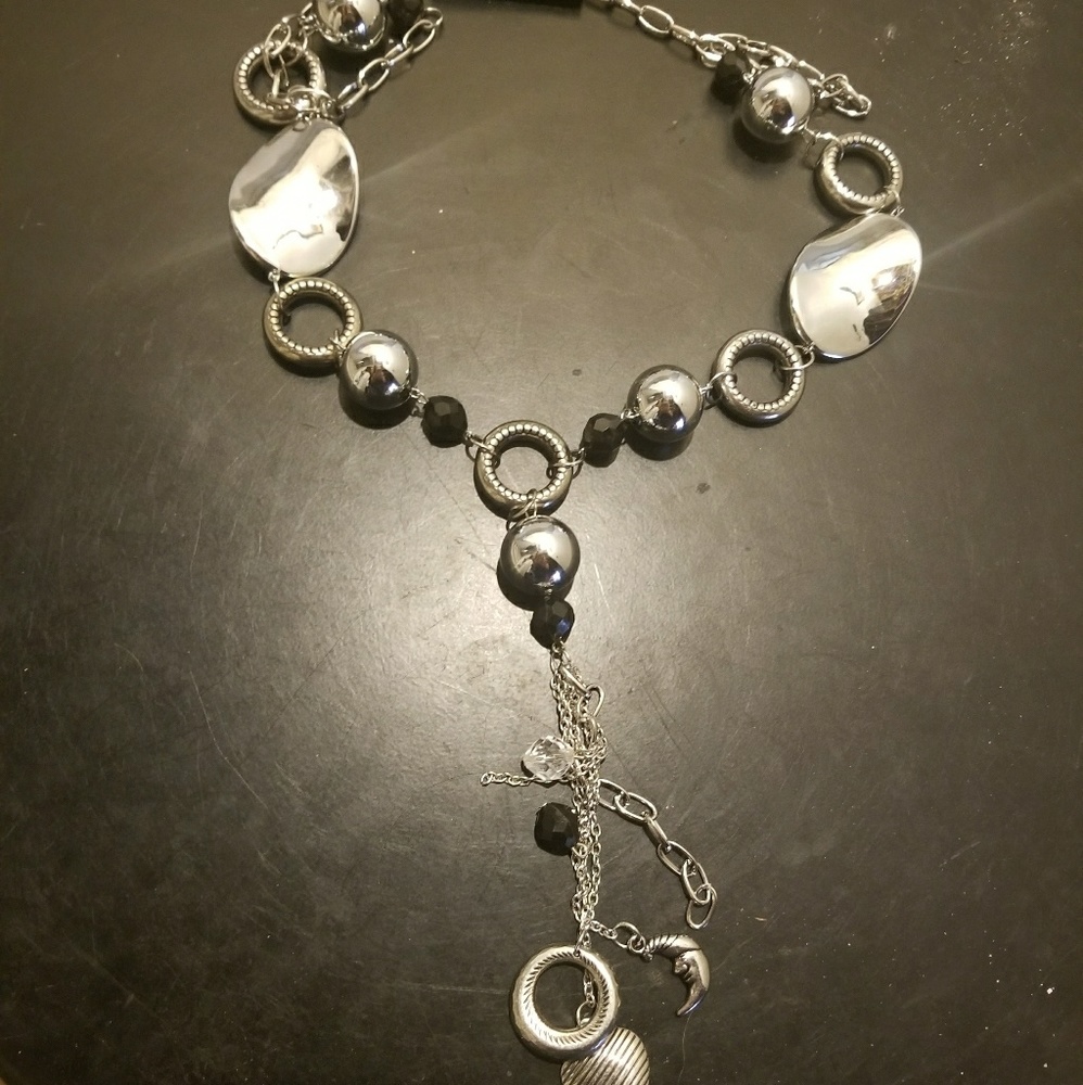 Silver accent necklace. With charms